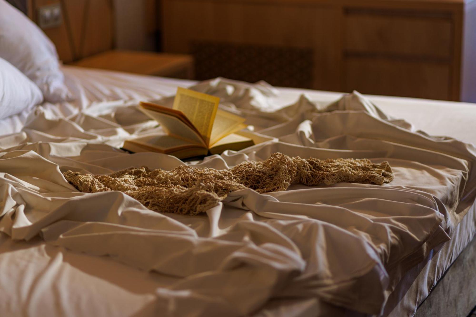 Secrets Sunny Beach Resort & Spa (Adults Only) Dış mekan fotoğraf A bed with a book and a cat
